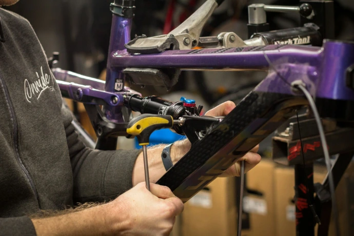Repairing a bike in a workshop environment.